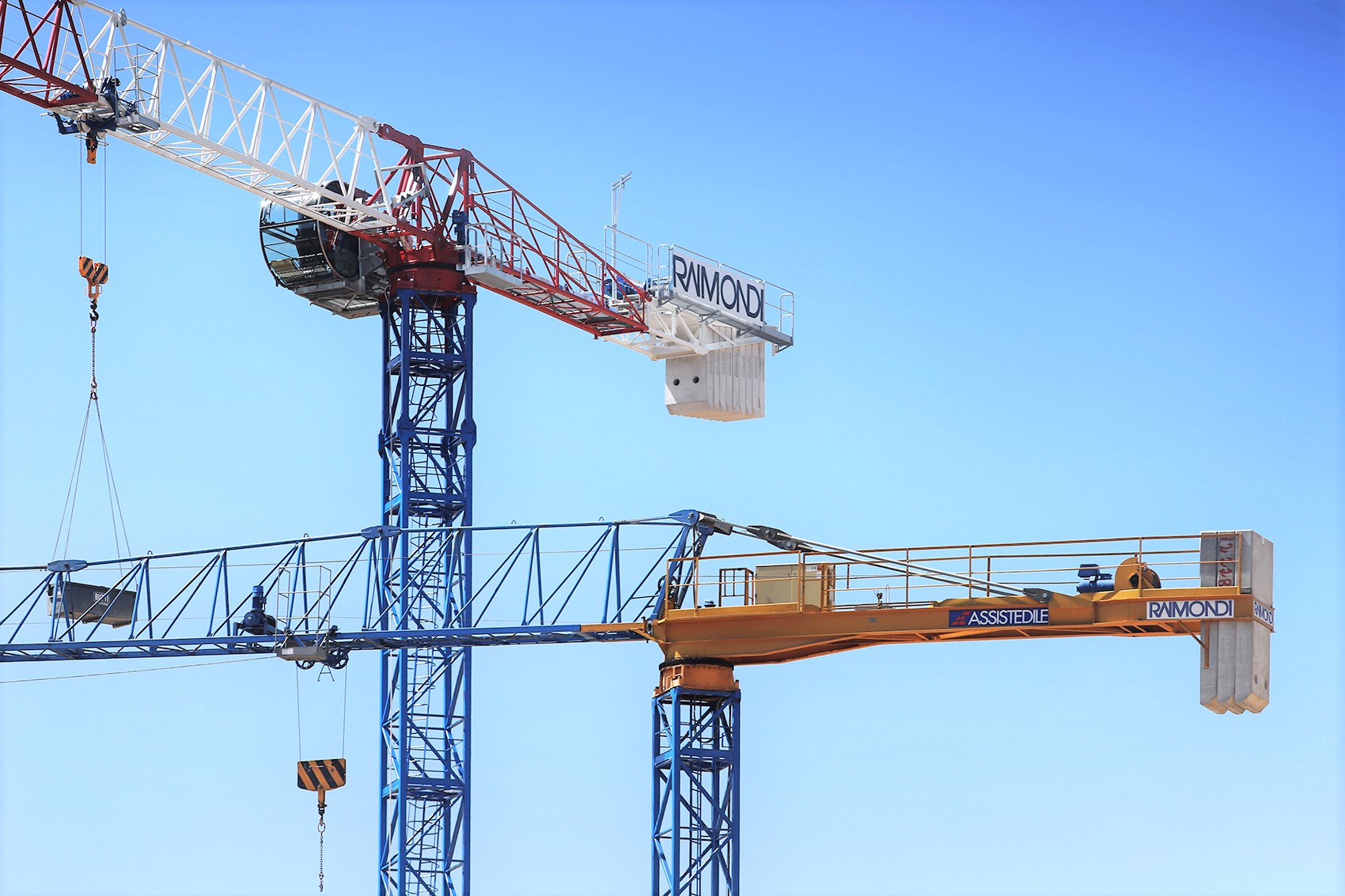 Two Raimondi topless tower cranes at work in historic district of Florence, Italy